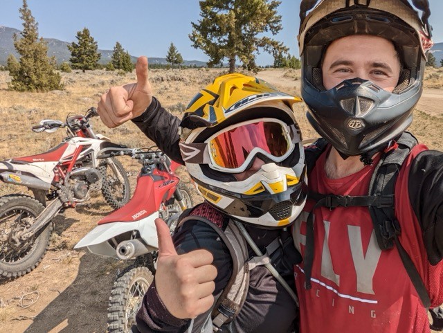 Two riders giving thumbs up on the trail